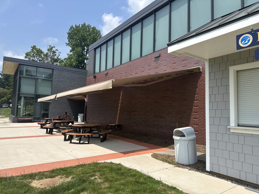 Commercial retractable awning over outdoor picnic seating