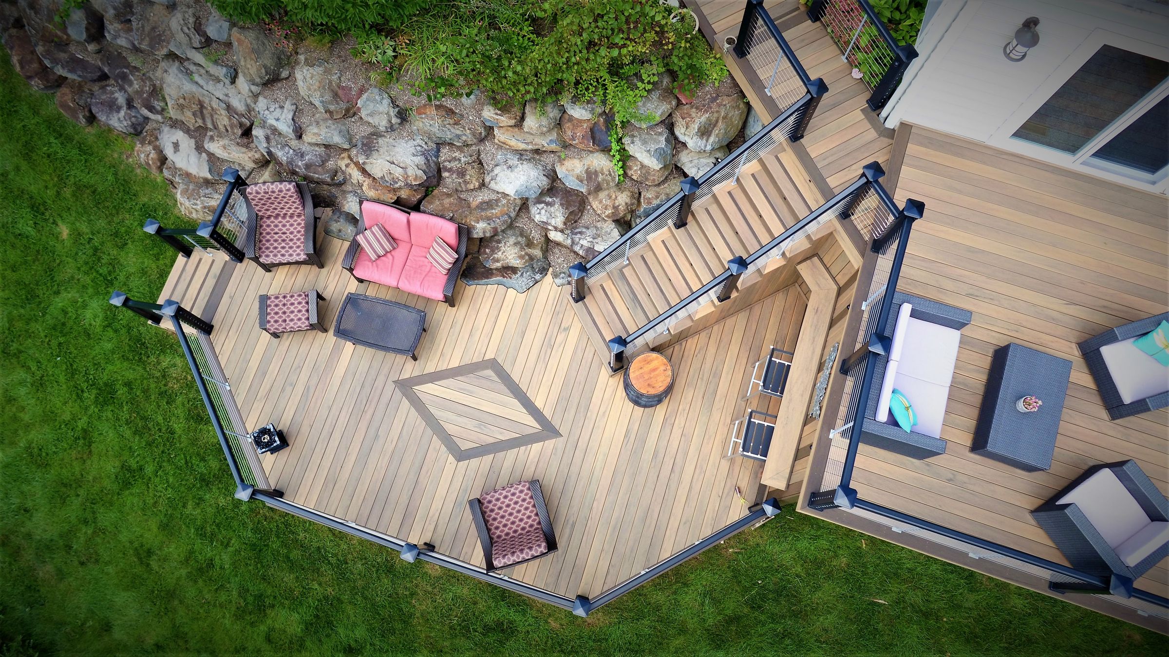 Aerial view of a composite deck with a fire table and seating