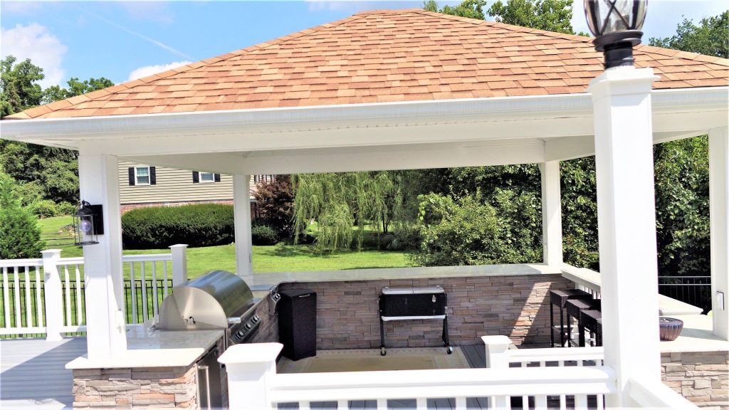 Gazebo covering an outdoor kitchen and seating area