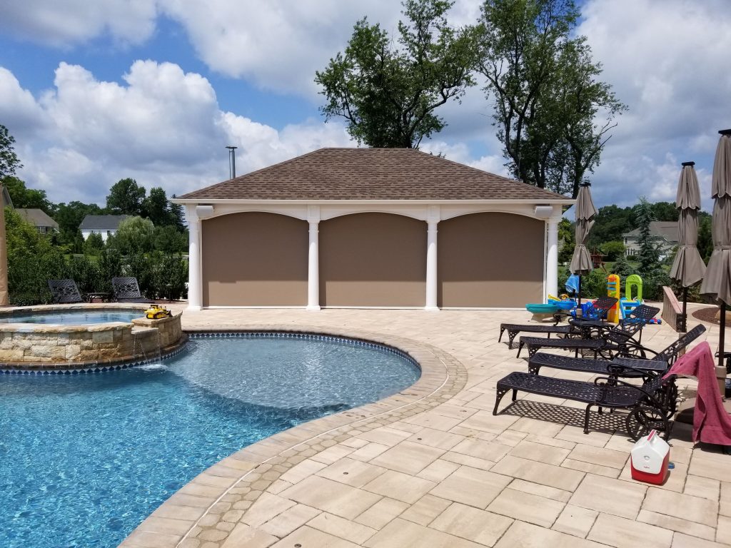 Retractable screens lowered on a covered patio