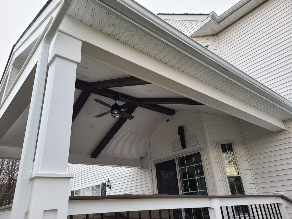 Vaulted roof structure ceiling with exposed beams and fans