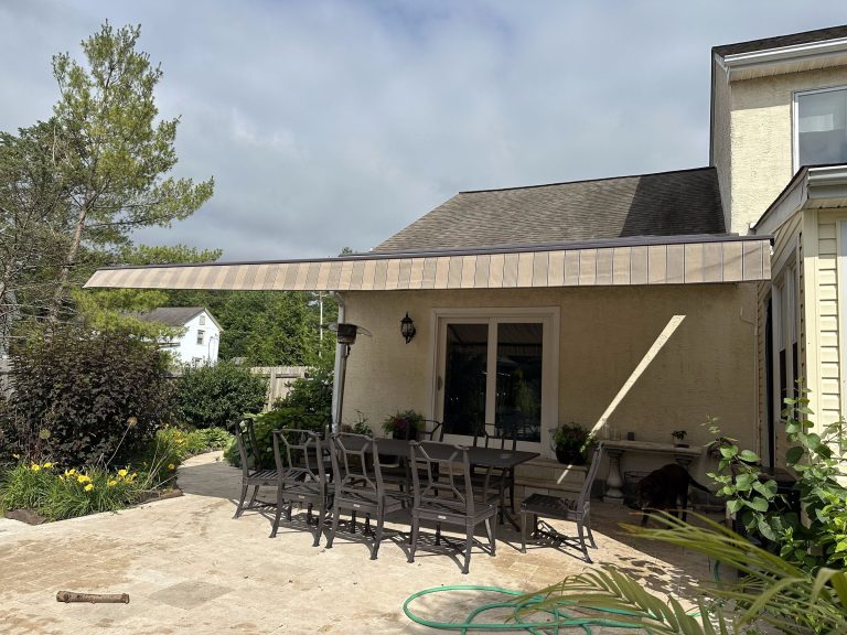 Sunesta retractable awning extended over a patio dining area