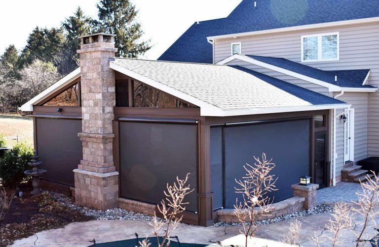 Covered patio pavilion with a stone fireplace chimney