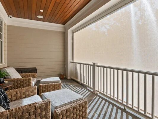 A fully screened-in backyard patio that allows the perfect amount of light in for perfect comfort.