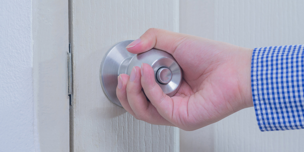 Hand turning a door knob