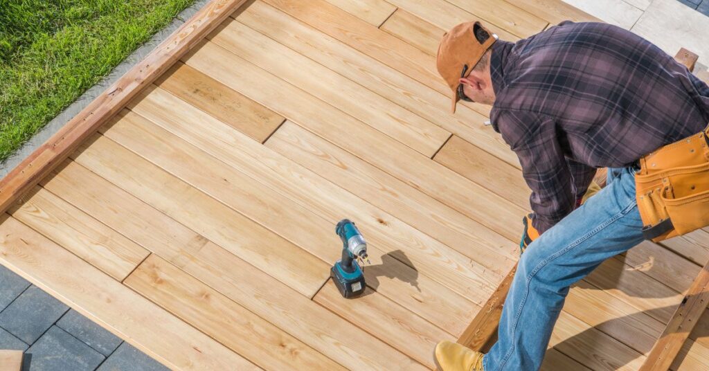 Carpenter fastening deck boards