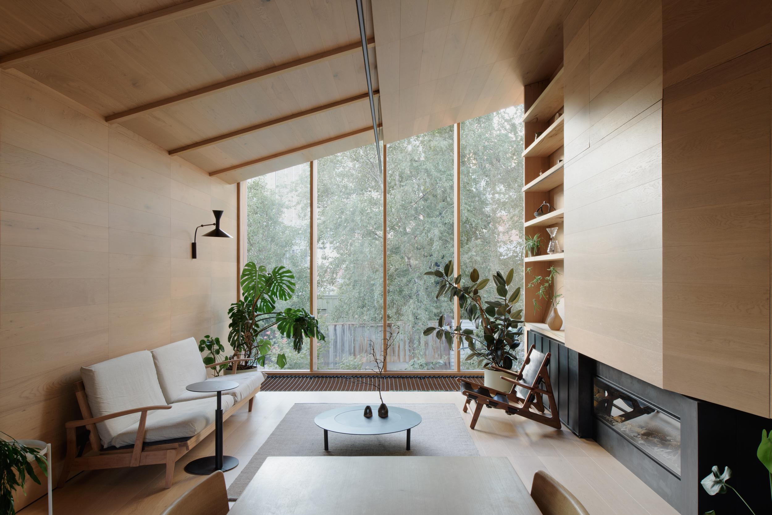 Bright sunroom with tall windows and lounge chairs